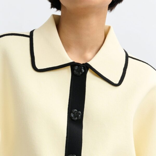 Essentiel Antwerp Off-white knit cardigan with flower buttons and black contrasting trims - Essentiel Antwerp Knitwear - Colorful Belgian Design - Shop at Coveti