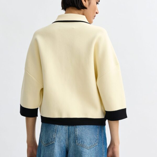 Essentiel Antwerp Off-white knit cardigan with flower buttons and black contrasting trims - Essentiel Antwerp Knitwear - Colorful Belgian Design - Shop at Coveti