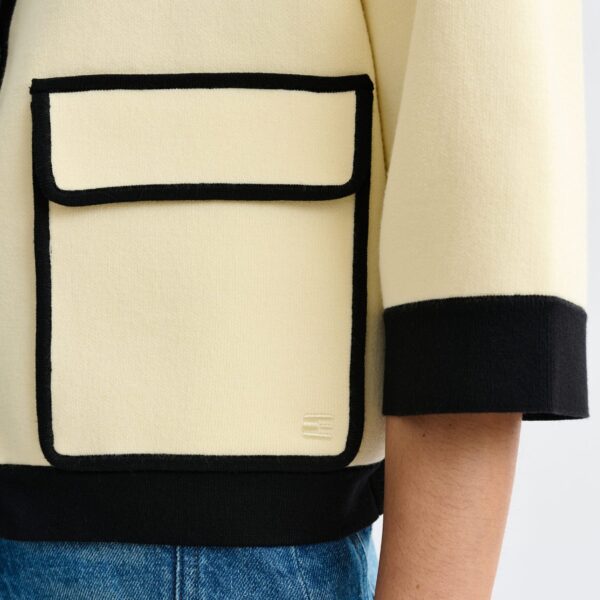 Essentiel Antwerp Off-white knit cardigan with flower buttons and black contrasting trims - Essentiel Antwerp Knitwear - Colorful Belgian Design - Shop at Coveti