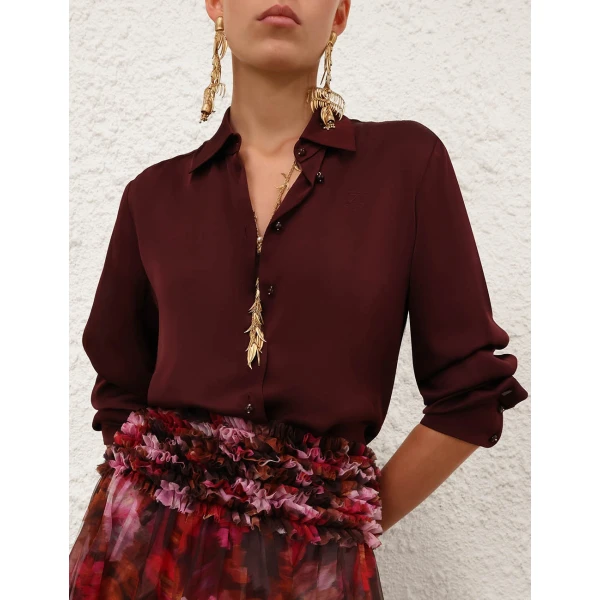 Elevate your elegance in this Zimmermann Tops available now at Coveti