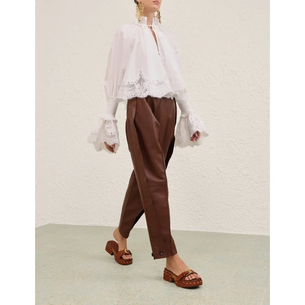 Elevate your elegance in this Zimmermann Tops available now at Coveti