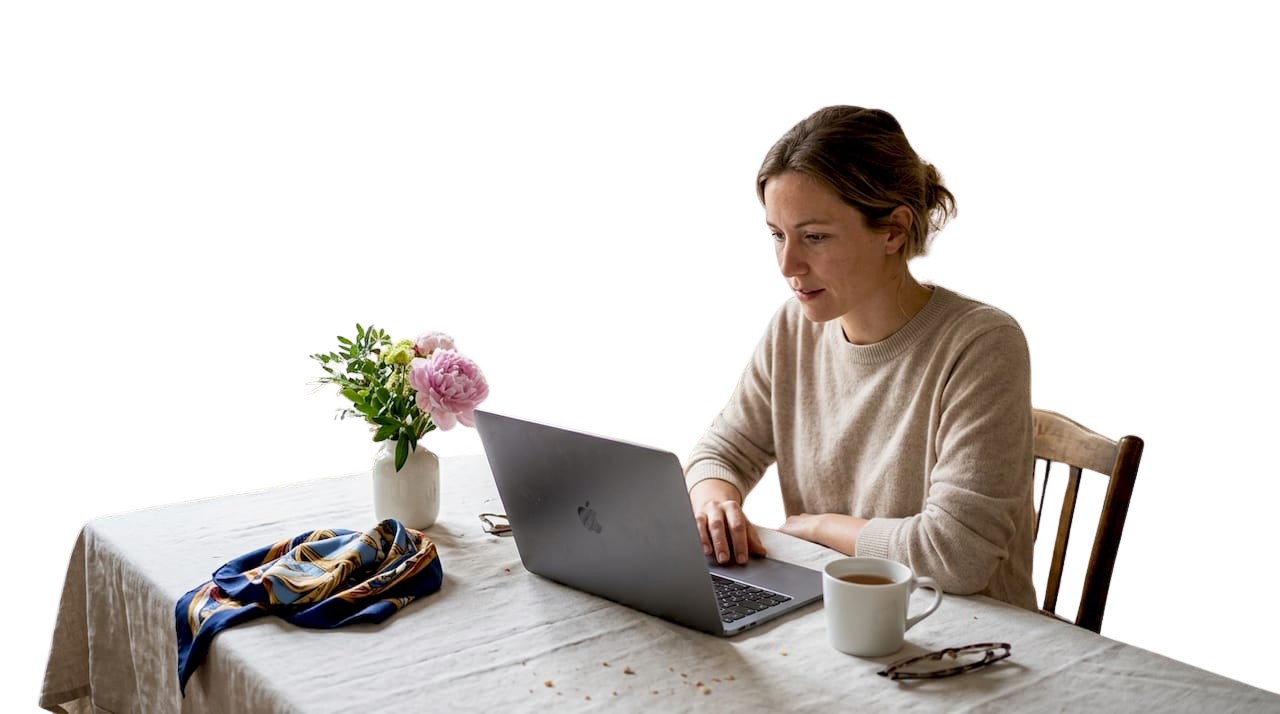 Installée confortablement chez elle, une femme explore les dernières tendances sur des sites de mode haut de gamme.