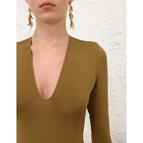 Elevate your elegance in this Zimmermann Bodysuit available now at Coveti