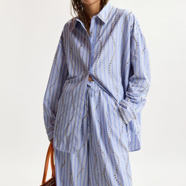 Essentiel Antwerp Light Blue And White Striped Oversized Shirt With Stud Embellishments - Essentiel Antwerp Tops - Colorful Belgian Design - Shop at Coveti