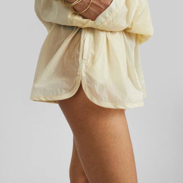 The Frankie Shop Bicos Sheer Mini Track Shorts - Pale Yellow - Oversized Minimalist Shorts in Yellow - Shop at Coveti