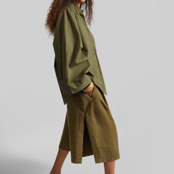The Frankie Shop Garment Dye Pleated Culotte - Avocado - Oversized Minimalist Shorts in Green - Shop at Coveti