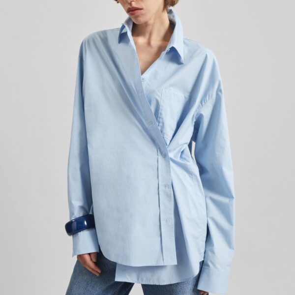 The Frankie Shop Ornella Side Button-Up Shirt - Light Blue - Oversized Minimalist Tops in Blue - Shop at Coveti