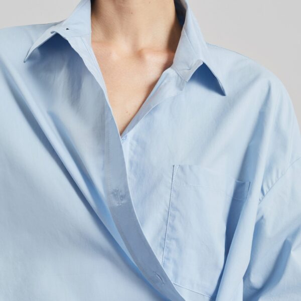The Frankie Shop Ornella Side Button-Up Shirt - Light Blue - Oversized Minimalist Tops in Blue - Shop at Coveti