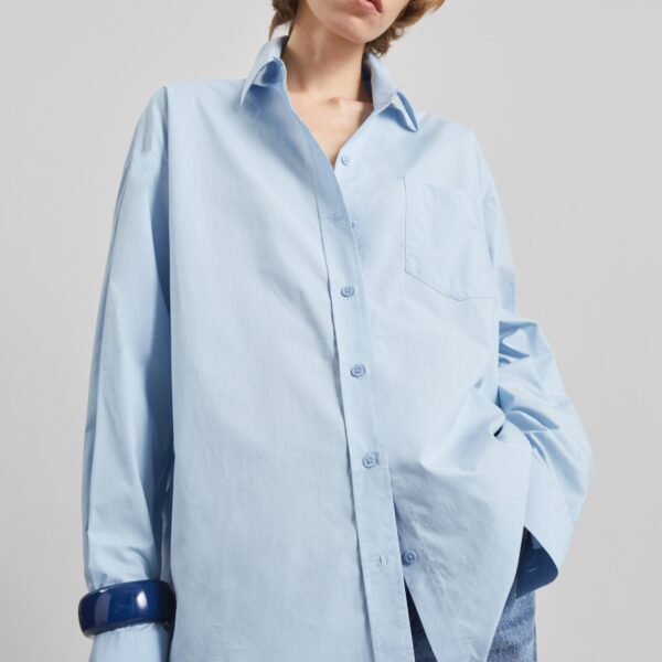 The Frankie Shop Ornella Side Button-Up Shirt - Light Blue - Oversized Minimalist Tops in Blue - Shop at Coveti