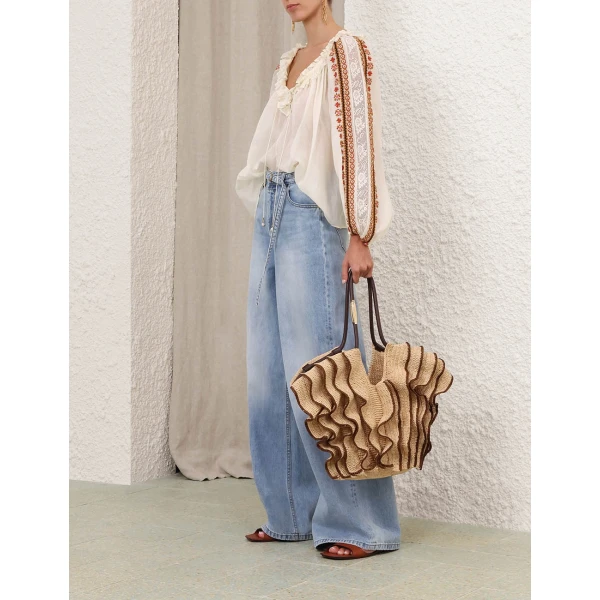 Elevate your elegance in this Zimmermann Tops available now at Coveti