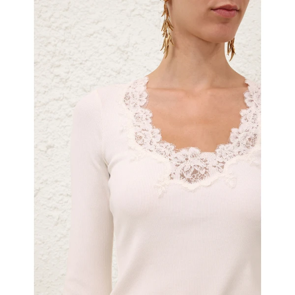 Elevate your elegance in this Zimmermann Tops available now at Coveti