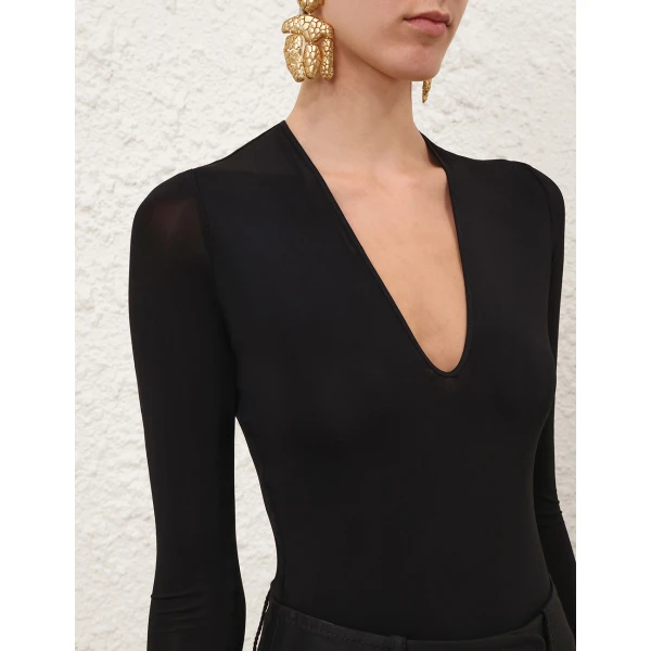 Elevate your elegance in this Zimmermann Tops available now at Coveti