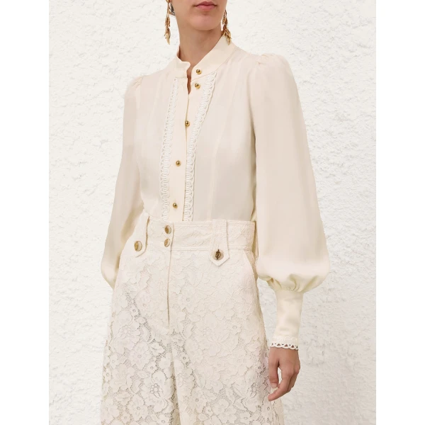 Elevate your elegance in this Zimmermann Tops available now at Coveti