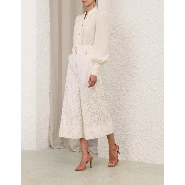 Elevate your elegance in this Zimmermann Tops available now at Coveti