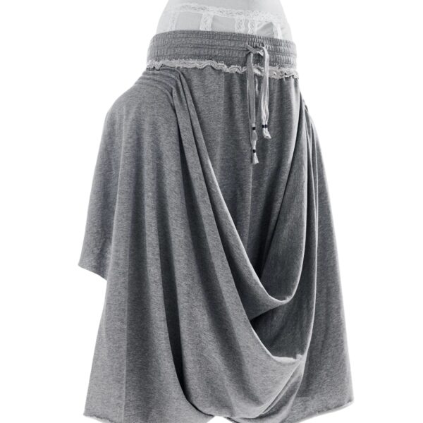 Light grey draped jersey pants with off-white lace undergarment