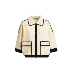 Off-white knit cardigan with flower buttons and black contrasting trims