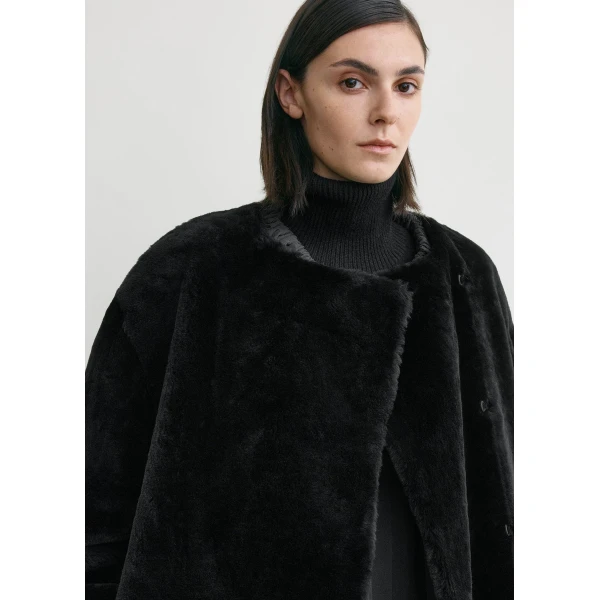 Totême Collarless shearling coat in Black - Coats - Scandinavian Minimalist Luxury at Coveti