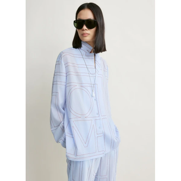 Totême Monogram cotton-blend pj top in Sky - Tops - Scandinavian Minimalist Luxury at Coveti