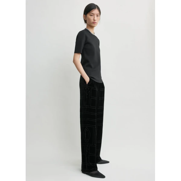 Totême Monogram devoré pj bottoms in Black - Pants - Scandinavian Minimalist Luxury at Coveti