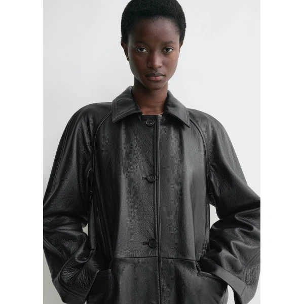 Totême Raglan-sleeve leather coat in Black - Coats - Scandinavian Minimalist Luxury at Coveti