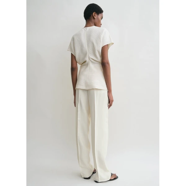Totême Slouch waist crinkled top in Cream - Tops - Scandinavian Minimalist Luxury at Coveti