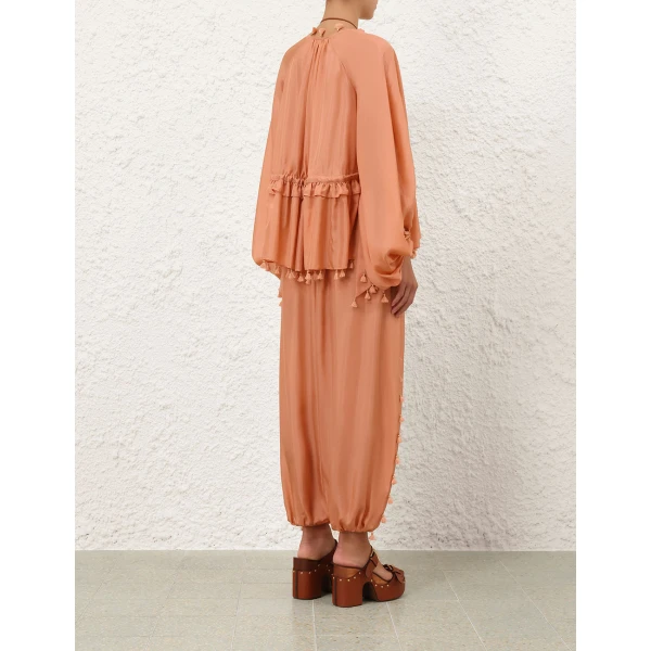 Elevate your elegance in this Zimmermann Tops available now at Coveti