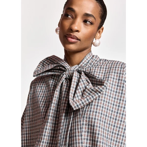 dark grey and off-white checked pussy-bow top with trumpet sleeves