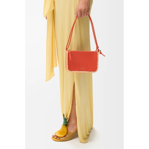 Loewe Rio pouch in classic calfskin and raffia, Deep Saffron | Clutch Bags | Coveti