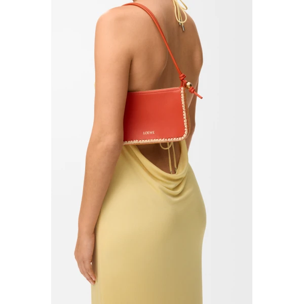 Loewe Rio pouch in classic calfskin and raffia, Deep Saffron | Clutch Bags | Coveti