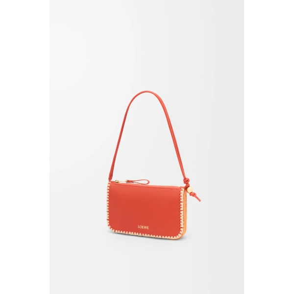 Loewe Rio pouch in classic calfskin and raffia, Deep Saffron | Clutch Bags | Coveti