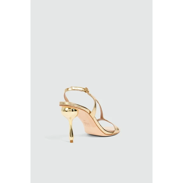 Aje Elan Asymmetric Droplet Heel in Gold | Heels | Coveti