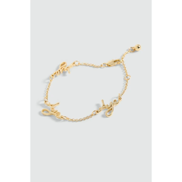 Aje Larissa Cursive Bracelet in Gold | Bracelets | Coveti