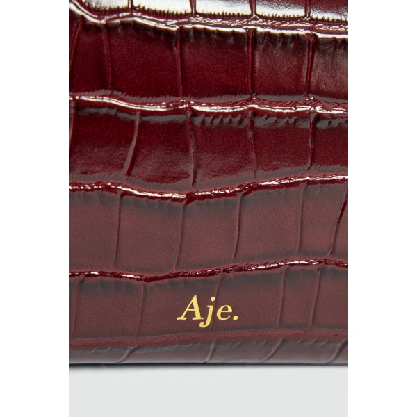 Aje Luna Long Clutch in Merlot Croc | Clutch Bags | Coveti