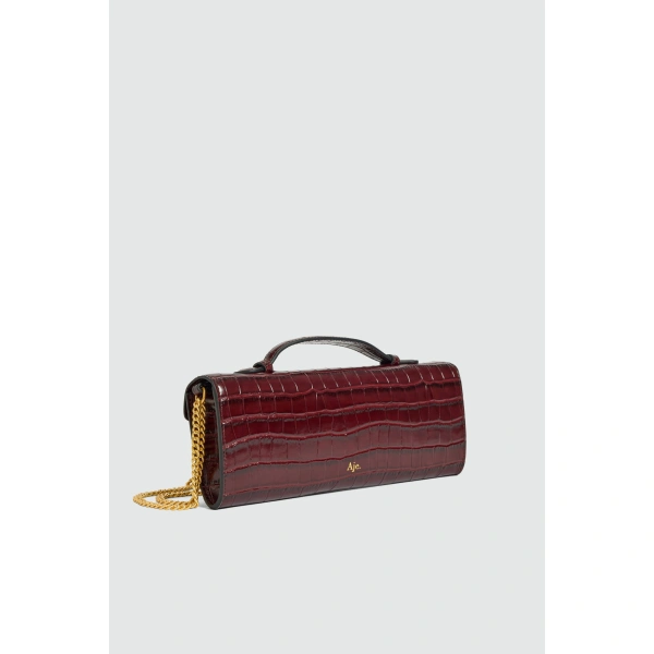 Aje Luna Long Clutch in Merlot Croc | Clutch Bags | Coveti
