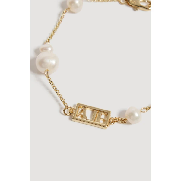Aje Swept Logo Pearl Bracelet in Gold | Bracelets | Coveti