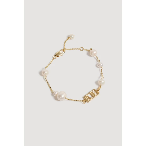 Aje Swept Logo Pearl Bracelet in Gold | Bracelets | Coveti