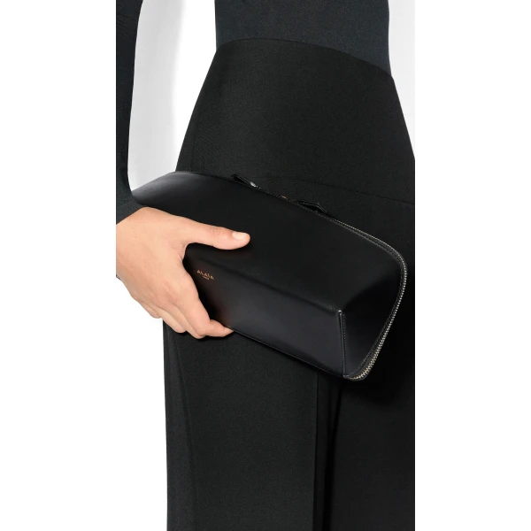 Alaia Delta Clutch in Perforated Vienne Calfskin, Black | Clutch Bags | Coveti