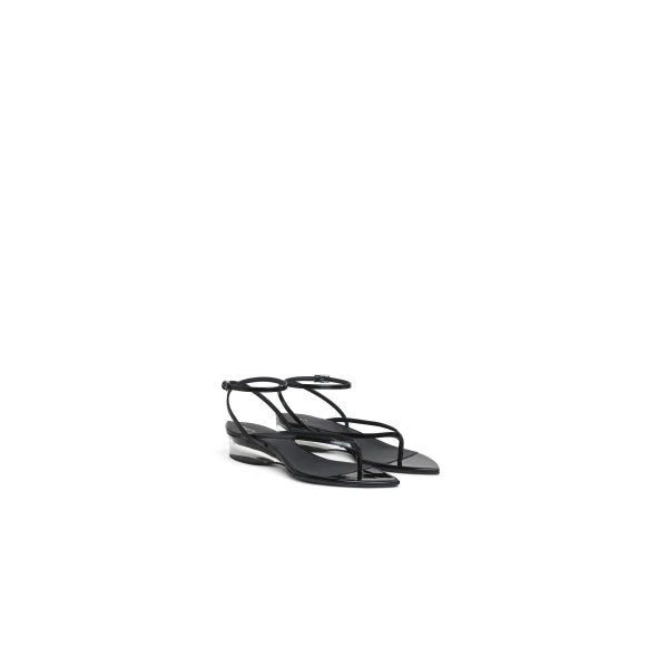 Alaia Invisible Thong in Patent Calfskin, Black | Sandals | Coveti