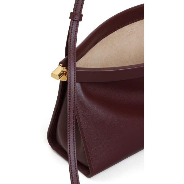 Alaia Le Click East West Medium Bag in Calfskin, Garnet Red | Shoulder & Crossbody Bags | Coveti