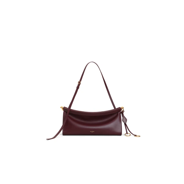 Alaia Le Click East West Medium Bag in Calfskin, Garnet Red | Shoulder & Crossbody Bags | Coveti
