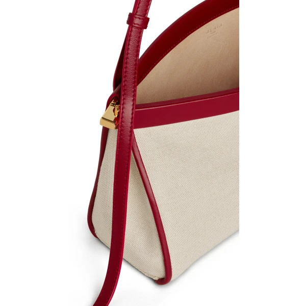 Alaia Le Click East West Medium Bag in Canvas, Natural and Red | Shoulder & Crossbody Bags | Coveti