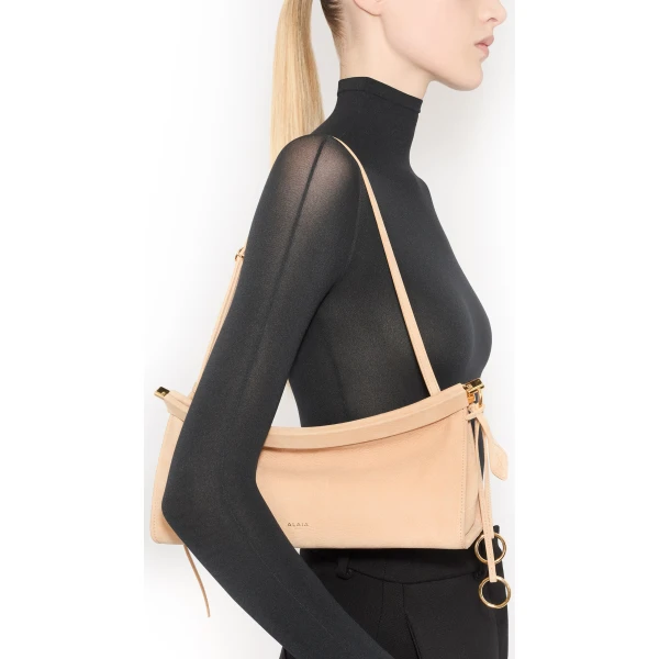 Alaia Le Click East West Medium Bag in Nubuck, Desert | Shoulder & Crossbody Bags | Coveti