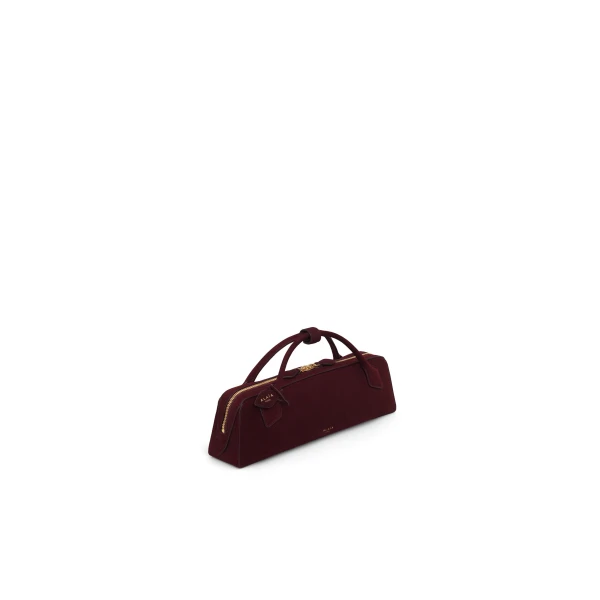 Alaia Le Teckel Clutch in Suede, Garnet Red | Clutch Bags | Coveti
