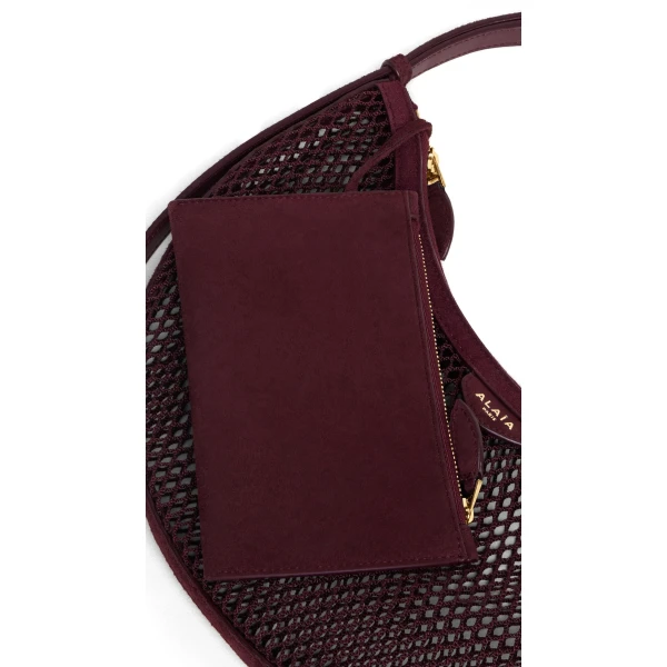 Alaia One Piece Demi Lune Bag in Fishnet and Suede, Garnet Red | Shoulder & Crossbody Bags | Coveti