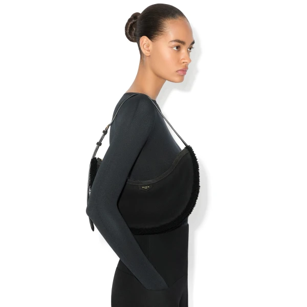 Alaia One Piece Demi Lune Bag in Merino Shearling, Black | Shoulder & Crossbody Bags | Coveti