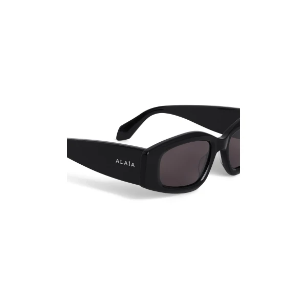Alaia Oval Sunglasses in Black | Sunglasses | Coveti