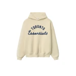 Fear of God Essentials Blue Jays Sport Hoodie in Oat | Coveti