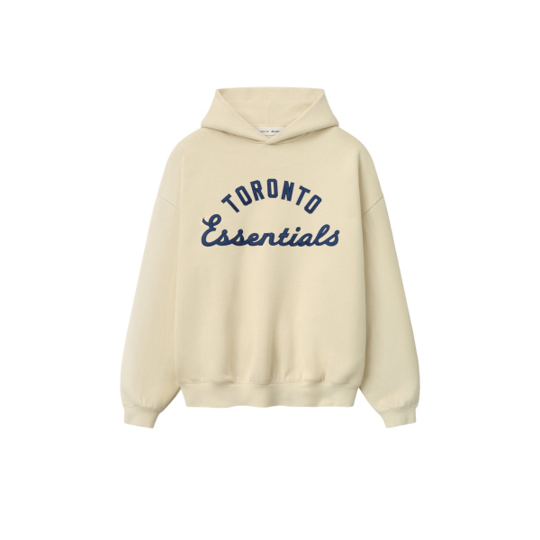 Fear of God Essentials Blue Jays Sport Hoodie in Oat | Coveti