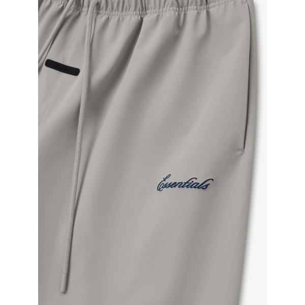 Fear of God Essentials Bonded Nylon Signature Relaxed Short with Slit in Stone | Shorts | Coveti