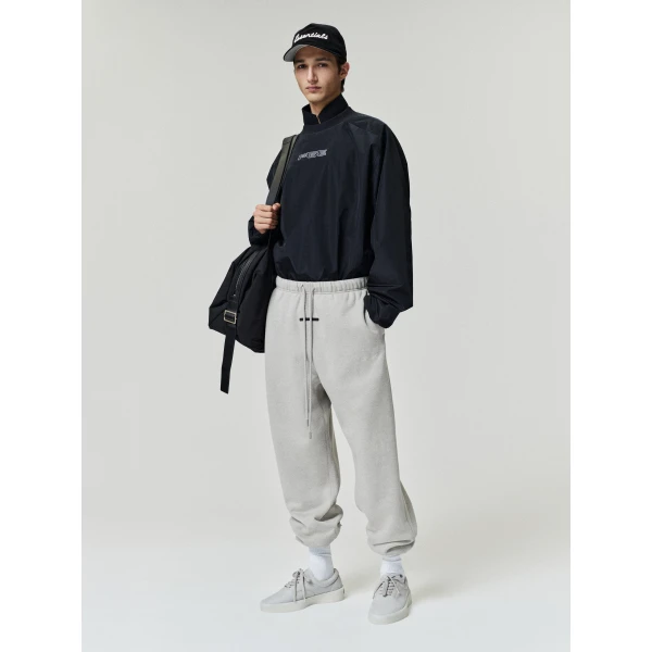 Fear of God Essentials Classic Slouchy Sweatpant in Pyrite Heather | Pants | Coveti